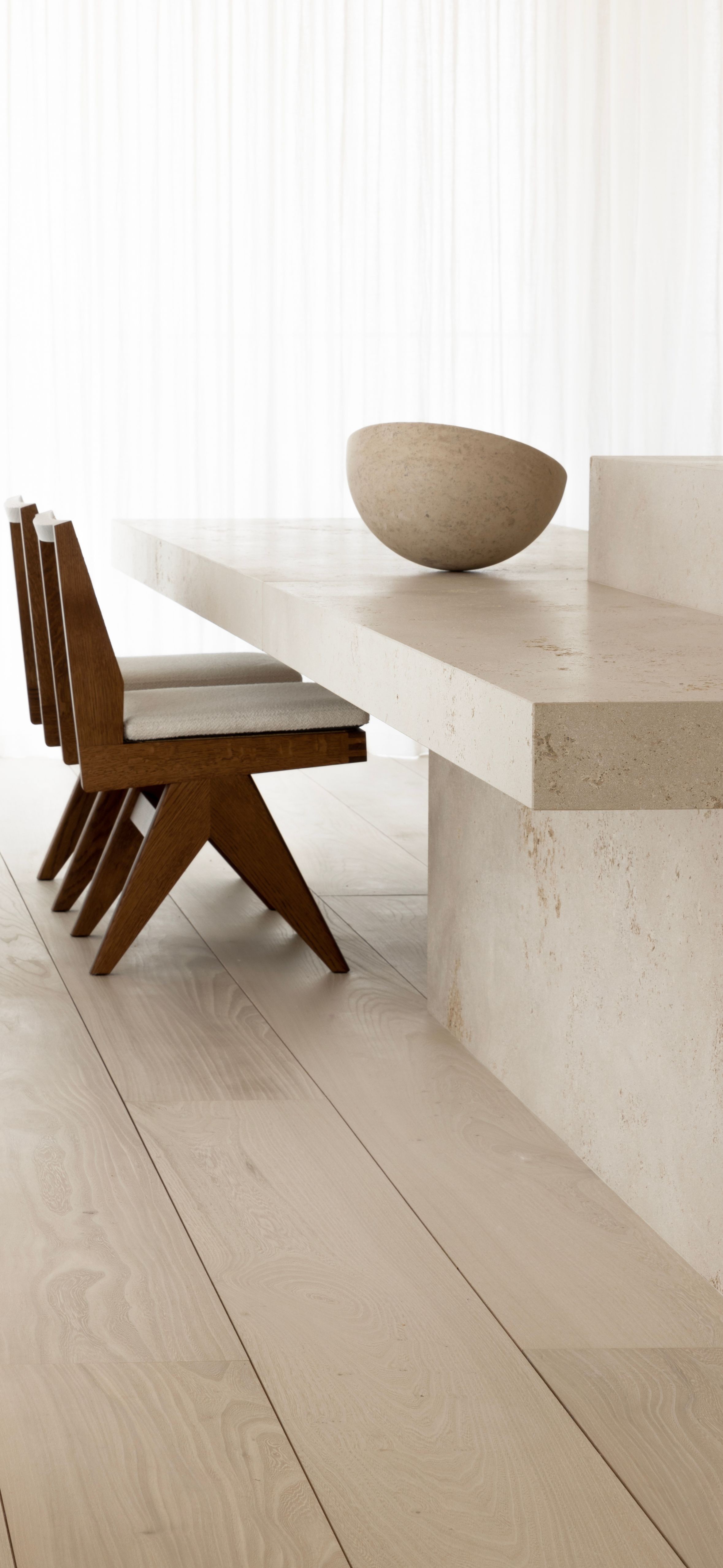 Wide plank oak flooring beside a travertine dining table, VOGUE Parquet