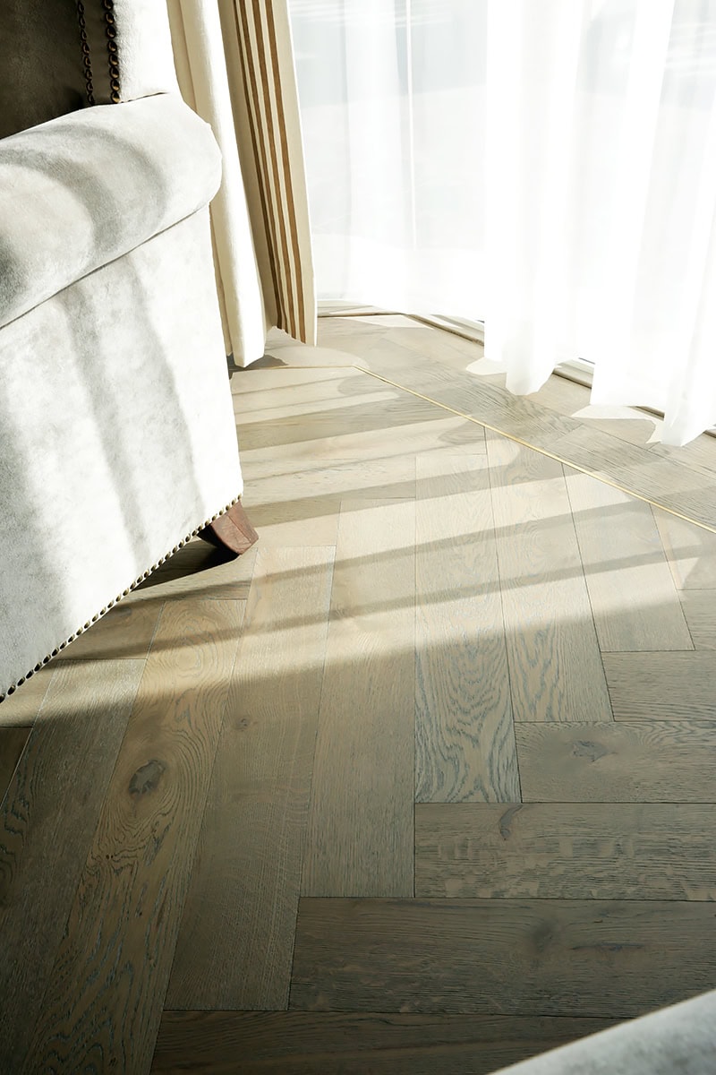 Metal insert wood flooring with brass finish