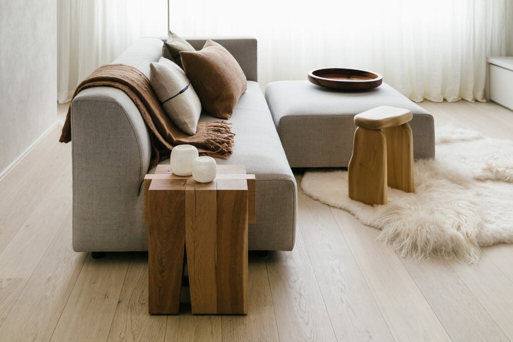 Scandinavian wood flooring with herringbone layout in soft neutral tones