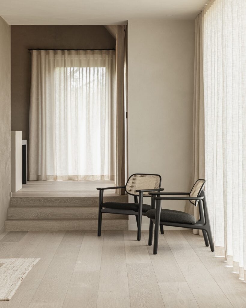 Wide plank dark French Oak floors with a hand-fumed finish, styled with linen drapery and bronze fixtures in a Coral Gables estate